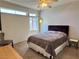 Cozy bedroom with ceiling fan, natural light, and comfortable furnishings at 3263 Quail Song Dr, Laughlin, NV 89029