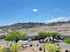 View of neighborhood homes nestled within a desert community with mountain views at 3263 Quail Song Dr, Laughlin, NV 89029