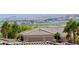 Scenic rooftop view overlooking palm trees and a lake at 3263 Quail Song Dr, Laughlin, NV 89029