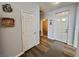 Bright hallway with wood flooring and access to rooms, showcasing the home's layout at 3263 Quail Song Dr, Laughlin, NV 89029
