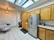 Well-lit kitchen with stainless steel refrigerator and ample cabinet space at 3263 Quail Song Dr, Laughlin, NV 89029
