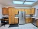 Spacious kitchen featuring ample cabinet space and stainless steel refrigerator at 3263 Quail Song Dr, Laughlin, NV 89029