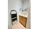 Functional laundry room with sink, cabinet, and shelf space at 3263 Quail Song Dr, Laughlin, NV 89029