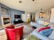 Spacious living room with fireplace, TV, and open access to dining and kitchen areas at 3263 Quail Song Dr, Laughlin, NV 89029