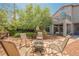 Beautiful backyard with mature trees, fire pit, covered patio and outdoor seating area at 3704 Blairmoor St, North Las Vegas, NV 89032
