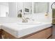 Bathroom with white tiled countertop and tile backsplash, sink with brushed nickel faucet, and wooden vanity at 3704 Blairmoor St, North Las Vegas, NV 89032