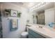 Bathroom with a blue vanity, white countertop, and decorative wall art at 3704 Blairmoor St, North Las Vegas, NV 89032