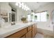 Bright bathroom with a double vanity, large mirror, and a separate bathtub at 3704 Blairmoor St, North Las Vegas, NV 89032