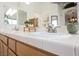 Bathroom with a double sink vanity, tiled countertops and a decorative mirror at 3704 Blairmoor St, North Las Vegas, NV 89032