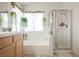 Bathroom featuring a bathtub, shower, and a window with plants at 3704 Blairmoor St, North Las Vegas, NV 89032
