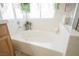 Soaking bathtub with tile surround and decor at 3704 Blairmoor St, North Las Vegas, NV 89032