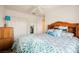 Bedroom featuring blue and white patterned bedding, a wood headboard, and a white closet at 3704 Blairmoor St, North Las Vegas, NV 89032