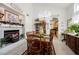 Dining room featuring a fireplace, chandelier, and access to the kitchen at 3704 Blairmoor St, North Las Vegas, NV 89032