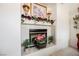 Tiled fireplace decorated with floral arrangements, wall art, and sconces at 3704 Blairmoor St, North Las Vegas, NV 89032