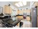 Charming kitchen featuring black countertops, light-colored cabinetry, and updated appliances at 3704 Blairmoor St, North Las Vegas, NV 89032