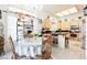 A kitchen featuring a dining table, modern appliances, and light wood cabinetry at 3704 Blairmoor St, North Las Vegas, NV 89032