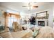 Spacious living room with fireplace, large windows, and view to kitchen area at 3704 Blairmoor St, North Las Vegas, NV 89032