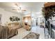Open-concept living room with tile floors, ceiling fan, and access to outdoor patio at 3704 Blairmoor St, North Las Vegas, NV 89032