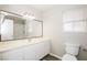 Bright bathroom featuring white vanity, a large mirror, and natural light from the window at 3751 Crellin Cir, Las Vegas, NV 89120