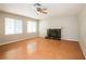 Bright living room featuring hardwood floors, a ceiling fan, and a cozy fireplace at 3751 Crellin Cir, Las Vegas, NV 89120