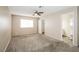 Comfortable primary bedroom with plush carpet, ceiling fan, walk in closet, and an en-suite bathroom at 3751 Crellin Cir, Las Vegas, NV 89120