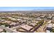 Extensive aerial perspective of a residential community, showcasing uniform landscaping and distant mountain views at 3904 Redbreast Ln, North Las Vegas, NV 89084