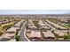 High aerial shot of a vast community, featuring many homes, green spaces, and distant city views at 3904 Redbreast Ln, North Las Vegas, NV 89084
