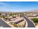 Expansive aerial view of a desert community, showcasing the neighborhood layout and mountain views at 3904 Redbreast Ln, North Las Vegas, NV 89084