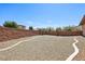 Backyard featuring rock landscaping, brick walls, and low-maintenance design with desert foliage at 3904 Redbreast Ln, North Las Vegas, NV 89084