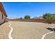 Open backyard with gravel landscaping and a decorative concrete perimeter for easy upkeep at 3904 Redbreast Ln, North Las Vegas, NV 89084