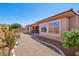 Serene backyard with gravel landscaping and a covered patio, perfect for relaxation and outdoor enjoyment at 3904 Redbreast Ln, North Las Vegas, NV 89084