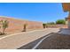 Low-maintenance backyard featuring gravel landscaping, palm trees, and a brick perimeter wall at 3904 Redbreast Ln, North Las Vegas, NV 89084