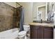 Bathroom features a tub and shower combo, modern fixtures, and a vanity sink at 3904 Redbreast Ln, North Las Vegas, NV 89084