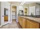 Spacious bathroom with double sinks, granite countertops, and a walk-in closet at 3904 Redbreast Ln, North Las Vegas, NV 89084