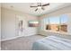 Bedroom featuring carpet, a ceiling fan, natural light, and a view of the backyard at 3904 Redbreast Ln, North Las Vegas, NV 89084