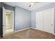Bedroom with gray walls, carpet, ceiling fan and closet with sliding doors at 3904 Redbreast Ln, North Las Vegas, NV 89084