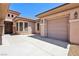 Spacious driveway leading to a three-car garage and inviting front entry of the well-maintained house at 3904 Redbreast Ln, North Las Vegas, NV 89084