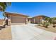 Attractive home with a spacious driveway, three-car garage, and carefully manicured desert landscaping at 3904 Redbreast Ln, North Las Vegas, NV 89084