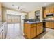 Open concept kitchen featuring an island, granite countertops and easy access to the dining and living area at 3904 Redbreast Ln, North Las Vegas, NV 89084