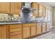 Close up of modern kitchen featuring granite countertops, stainless steel vent hood and ample cabinet space at 3904 Redbreast Ln, North Las Vegas, NV 89084