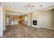 Open-concept living area featuring tile flooring and a fireplace that connects to the kitchen at 3904 Redbreast Ln, North Las Vegas, NV 89084