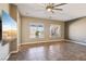 Open living room with tile flooring, two large windows and ceiling fan at 3904 Redbreast Ln, North Las Vegas, NV 89084