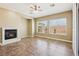 Living room featuring tile flooring, neutral walls, fireplace, and abundant natural light from large windows at 3904 Redbreast Ln, North Las Vegas, NV 89084