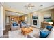 Bright living room with a fireplace, plush seating, and an open floor plan leading to the kitchen at 3904 Redbreast Ln, North Las Vegas, NV 89084