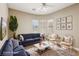 Living room with neutral walls, a ceiling fan and an area rug, creating a cozy atmosphere at 3904 Redbreast Ln, North Las Vegas, NV 89084