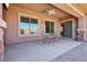 Inviting covered patio with stone pillars, offering a comfortable and stylish outdoor living space at 3904 Redbreast Ln, North Las Vegas, NV 89084