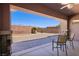 Charming covered patio with stone accents and a cozy outdoor seating area overlooking the yard at 3904 Redbreast Ln, North Las Vegas, NV 89084