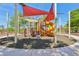 Colorful playground with climbing wall, slides, and shade, perfect for to play and enjoy the outdoors at 3904 Redbreast Ln, North Las Vegas, NV 89084