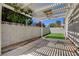 Backyard featuring an outdoor living area with a pergola, artificial grass, and block wall fencing at 4052 Compass Rose Way, Las Vegas, NV 89108