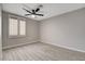 Bedroom with wood-look tile floors, ceiling fan, and window with blinds at 4052 Compass Rose Way, Las Vegas, NV 89108